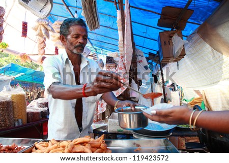 THELLIYOOR, INDIA - NOV 20 : An instant food maker sells food at a Rural exhibition on November 20, 2012 in Thelliyoor, India. The exhibition was held to promote Kerala\'s retro style house hold items