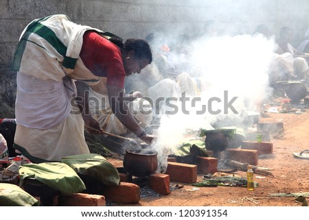 CHAKKULATHUKAVU, INDIA - NOV 28: Women devotees participate in the Pongala  ceremony where boiled rice made in clay pots is offered to the goddess on November 28, 2012 in Chakkulathukavu,Kerala,India.