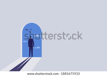 Businessman standing on a door opened to a blue sky filled with clouds and birds