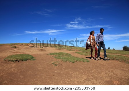 OOTY, INDIA - DEC 05: Unidentified couple walk over the hills on December 05, 2012 in Ooty, India. Ooty is a popular tourist destination in South India also known as Queen of hill stations.