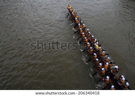 PAYIPPAD, INDIA - SEPT 18: A snake boat team participate in the Payippad Boat race on September 18, 2013 in Payippad, Kerala, India. Boat races are the major sporting events in Kerala.