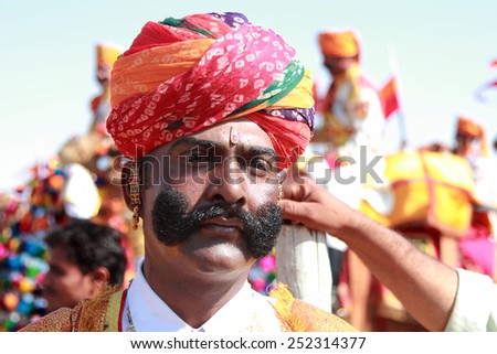 JAISALMER, INDIA - FEB 01: Unidentified traditionally dressed Rajasthani villager attends a cultural procession for the Desert festival held on February 01, 2015 in Jaisalmer, Rajasthan, India.