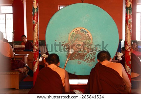BYLAKUPPE, INDIA - MAR 27, 2015 : Buddhist monks beat drums during prayer at Namdroling Monastery on March 27, 2015 in Bylakuppe,India. Bylakuppe is second largest Tibetan refugee settlement in India.