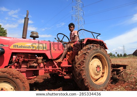 SHENGOTTAI, INDIA - SEP 25: An unidentified farmer in tractor prepare his farm land for cultivation on September 25, 2010 in a village in Shengottai, Tamil Nadu, India.