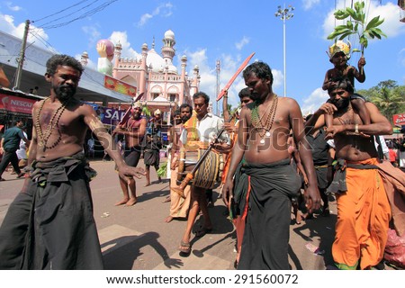 ERUMELI, INDIA - JAN 12 : Devotees sing and dance in the Petta Thullal procession on January 12, 2012 in Erumeli, India. Petta Thullal is a mass frenzied dance performed by devotees of Lord Ayyappa.