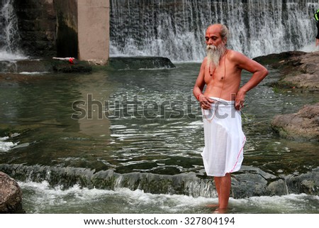 NASHIK - SEP 14:An unidentified sadhu takes bath in the river Godavari during the event Kumbh Mela on September 14, 2015 in Nashik, India.Kumbhmela is a Hindu religious event gathered by millions.