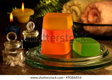 Candle light display of handmade soaps, towel and perfume oils.