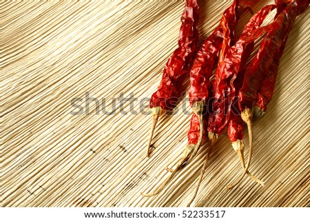 Dried red chillies on a dry palm leaf