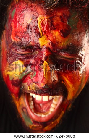A man with painted face screaming loud