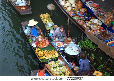 RATCHABURI, THAILAND - FEB 13: Local people sell food items at Damnoen Saduak floating market on February 13, 2011 in Ratchaburi, Thailand. Damnoen Saduak is a very popular tourist attraction.