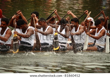 KUMARAKOM, INDIA - AUGUST 24 : Oarsmen of a snake boat team row aggressively in the Kumarakom Boat race on August 24, 2010 in Kumarakom, Kerala, India.