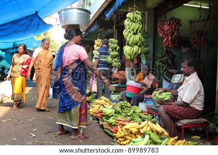 TRIVANDRUM - DEC 02: Unidentified vendor sells vegetables in a crowded  market on December 02, 2011 in Chalai, Trivandrum, India. Chalai is the biggest market in the capital city of Kerala state.