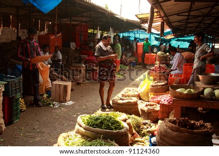 TRIVANDRUM - DEC 02: Unidentified vendors wait for customers in a crowded market on December 02, 2011 in Chalai, Trivandrum, India. Chalai is the biggest market in the capital city of Kerala state.