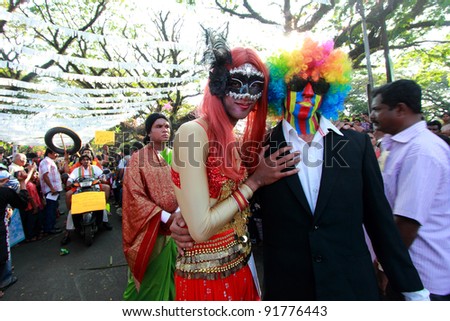 COCHIN, INDIA - JAN 01 : An unidentified couple wear carnival masks during the Cochin Carnival New Year\'s day celebration on January 01, 2012 in Fort Cochin, Kerala, India.