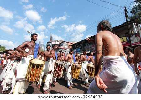 ERUMELI, INDIA - JAN 12 : Devotees sing and dance at the Petta Thullal procession on January 12, 2012 in Erumeli, India. Petta Thullal is a mass frenzied dance performed by devotees of Lord Ayyappa.