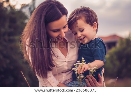 Similar – Image, Stock Photo Young mom playing with her baby in the sand