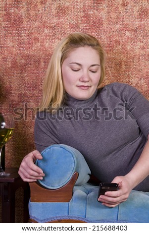 Beautiful Woman Relaxing byLaying on the Couch and Drinking Wine