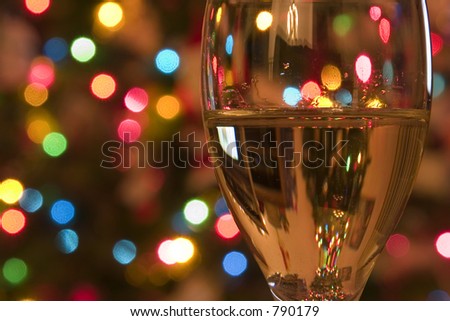 Close up on a Wine Glass with the Christmas lights on the background