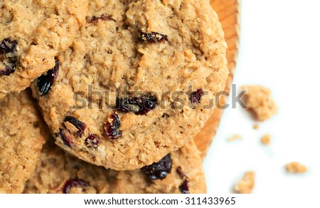 Fresh baked cookies with raisin with crumbs isolated on white
