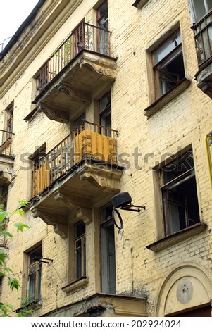 Abandoned uninhabited house with broken windows before renovation side view vertical photo closeup