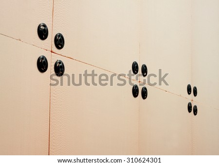 Modern insulation panels are mounted on the wall of a house under construction. Diagonal view closeup