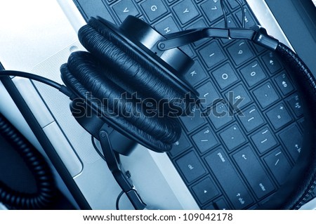 Digital Music Composer Theme. Modern Laptop Computer and Large Professional Headphones. Digital Music Composer Workstation. Technology Photo Collection