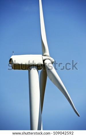 Side Closeup of Wind Turbine. Alternative Energy Theme. Vertical Photography