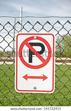 No Parking Sign on Fence. No Parking Along Fence