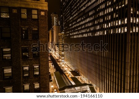 Wall of Downtown Chicago at Night. Golden Color Grading. Train Route and Streets.