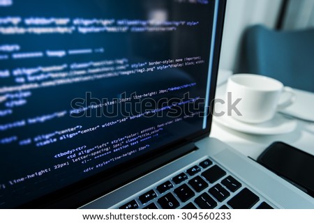 Website Coding. Website HTML Code on the Laptop Display Closeup Photo. Webdesigner Workstation.
