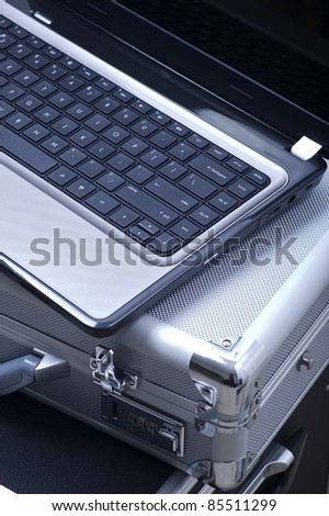 Mobile Office Theme. Laptop Computer with Silver Documents Case. Mobile Office Vertical Photo.