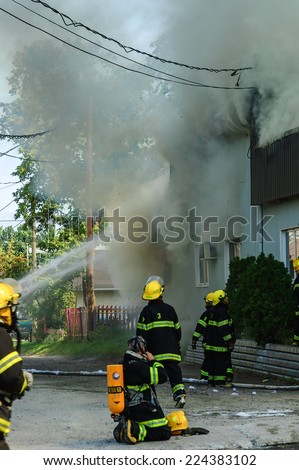 Quebec,Canada - August 30, 2006 : Firefighters on the move, fighting  burning building in a rural country, Quebec, Canada