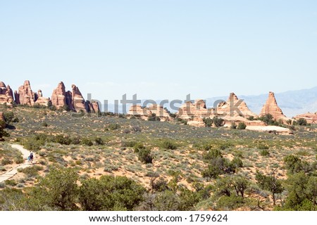 hikers in Park Avenue of  Arches National Park,  Moab, Utah, USA