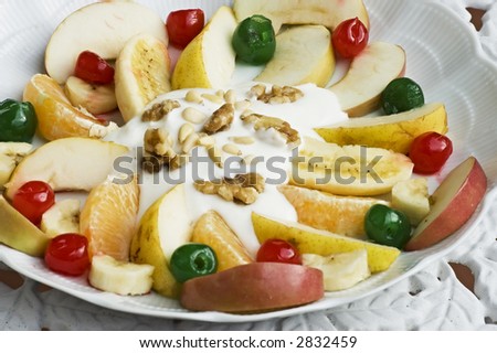 Fruit salad plate with yogurt and nuts.Good presentation for recipes book. Shallow DOF, focus on middle