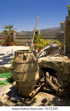 clay jar and alembic still used to distill alcohol on a balcony of on  Crete island, Greece