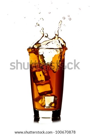 Ice cube  in cola glass and cola splashing