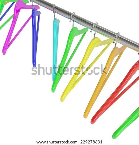 Row of color rainbow coat hangers on metal shiny clothes rail isolated on white background