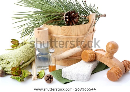 Wooden bucket with ladle for the sauna and stack of clean towels