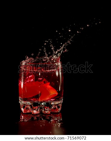Orange in red water splash on black background