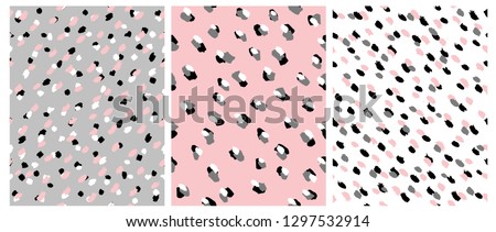 Set of 3 Cute Abstract Dots Vector Pattern. White, Pink, Black and Gray Irregular Brush Dots on a White, Gray and Pink Backgrounds. Lovely Pastel Color Delicate Layouts. Abstract Wild Animal Skin.