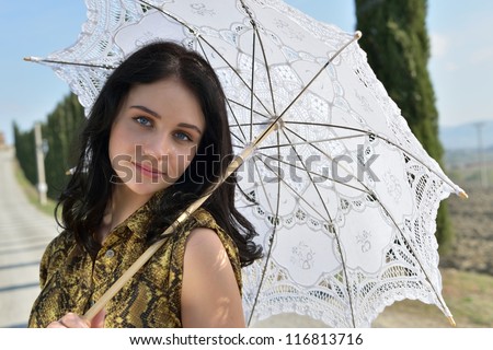 Portrait of innocent young woman with white umbrella on sunny day