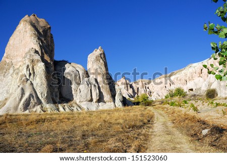 View of Cappadocia. Turkey. Unusual landscape with cliff and dirt road at evening time