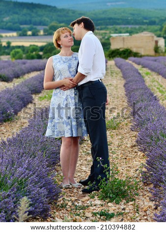 Portrait of young sensual loving couple in a lavender field at sunset. Provence, France