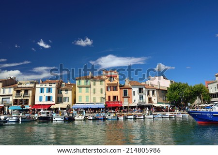 CASSIS, FRANCE - JULY 14, 2014: A picturesque tourist port in the south of France called Cassis. Cassis is a famous port where tourists charter boats to view the calanques.