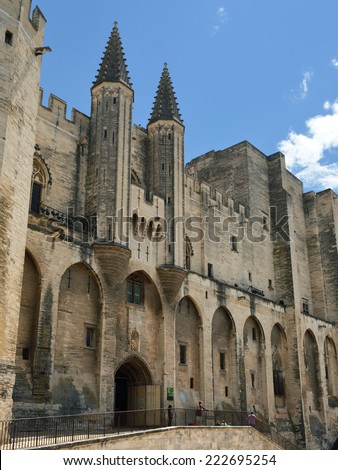 AVIGNON, FRANCE - JUL 12, 2014: Tourists visit Popes Palace. Popes Palace is the main historical site in Provence and one of the largest and most important medieval Gothic buildings in Europe