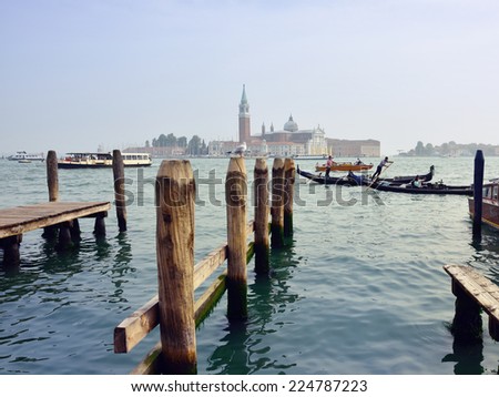 VENICE - SEP 21, 2014: View from  the Venice San Marco seafront on San Giorgio di Maggiore church.Tourists from all the world enjoy the historical city of Venezia in Italy,  UNESCO Heritage Site