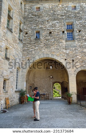BARROUX, FRANCE - JUL 17, 2014: Tourists visit the medieval castle of Barroux. Castle is located in the small village but have a reputation as one of the most picturesque castle in Provence, France