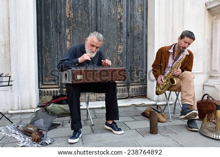 VENICE, ITALY - SEPT 27, 2014: Unidentified musicians perform in the street in Venice. This is one of the popular for outdoor performances in Venece, famous UNESCO World Heritage Site