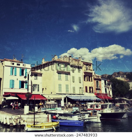 CASSIS, FRANCE - JUL 14, 2014: A picturesque tourist port in the south of France called Cassis. Cassis is a famous port where tourists charter boats to view the calanques. Filtered image