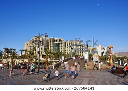 EILAT, ISRAEL - MARCH 31, 2015: Tourist walking on central square in Eilat at sunset time, famous international resort - the southest city of Israel